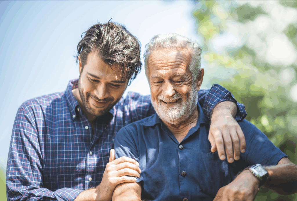 Father and son, dressed in blue shirts, smiling.